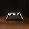 Front view of Metallica Band Logo Heavy Metal LED lightbox sign glowing on a wooden desk