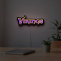 Minnesota Vikings NFL Pro Football LED lightbox hanging on a room wall with soft purple light