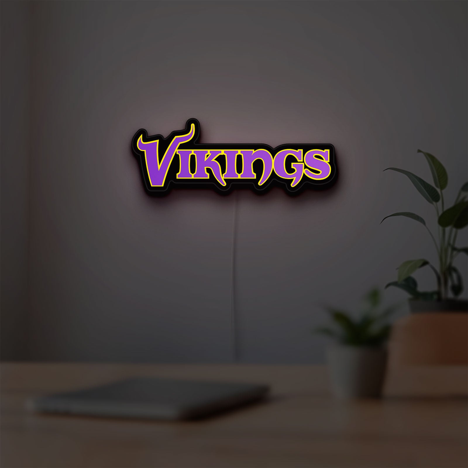 Minnesota Vikings NFL Pro Football LED lightbox hanging on a room wall with soft purple light