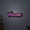Minnesota Vikings NFL Pro Football LED lightbox hanging on a wall with purple glow
