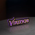 Minnesota Vikings NFL Pro Football LED lightbox standing on a desk from an angled side view with purple glow