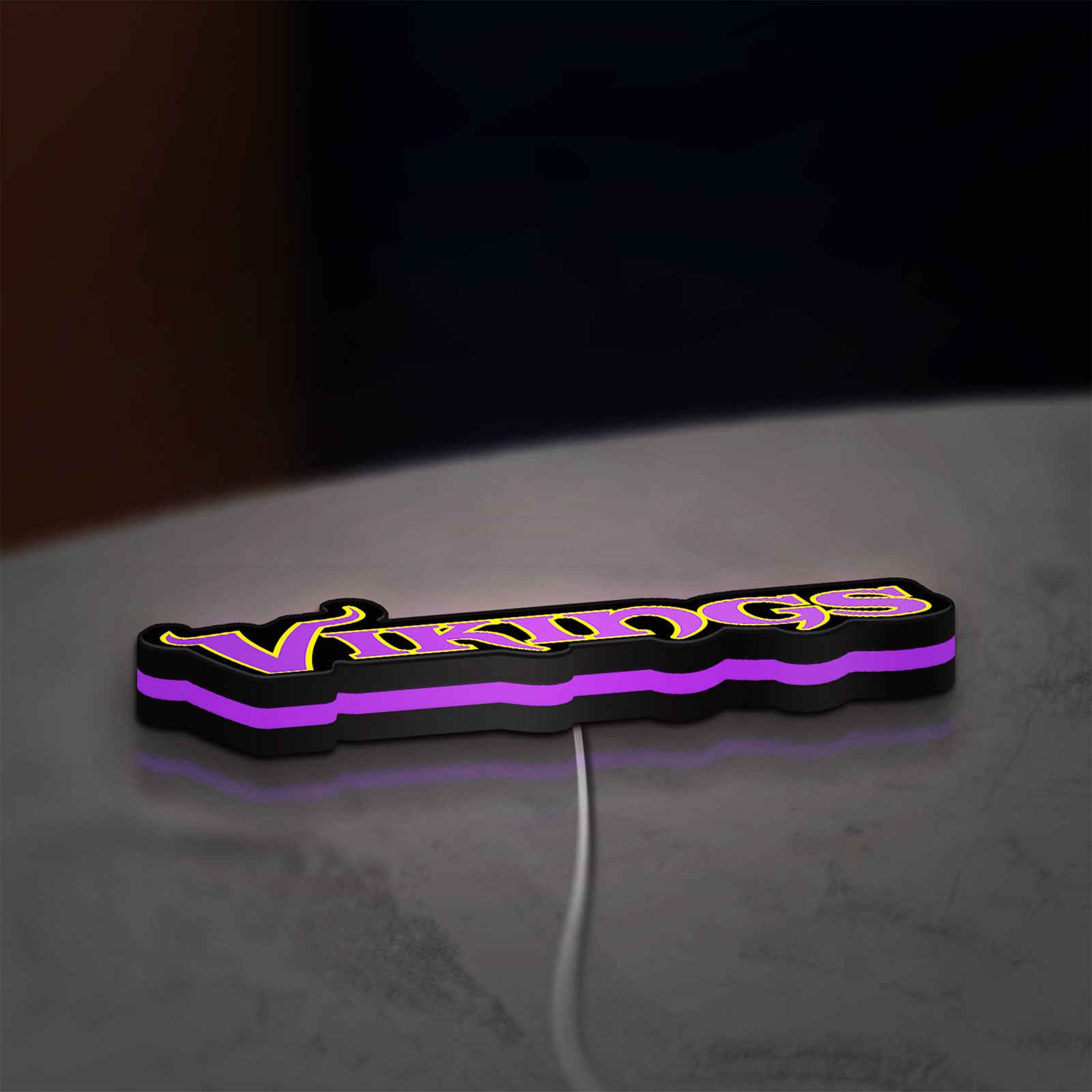 Minnesota Vikings NFL Pro Football LED lightbox lying flat on a desk with purple glow