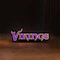 Front view of Minnesota Vikings NFL Pro Football LED lightbox sign glowing on a wooden desk