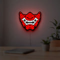 Oni Mas LED lightbox hanging on a room wall with soft red light