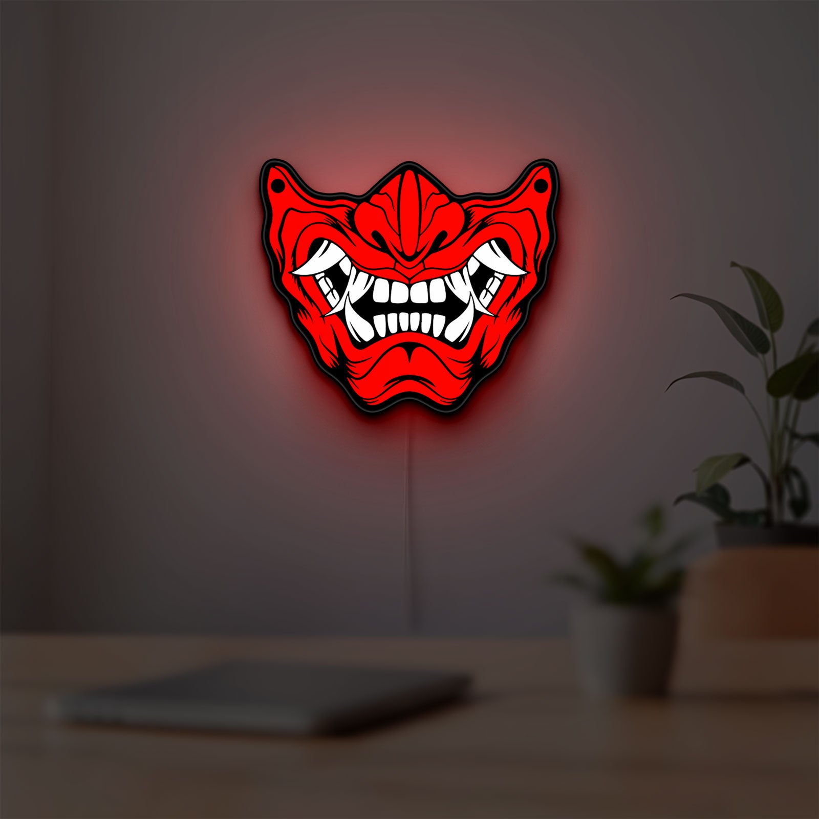 Oni Mas LED lightbox hanging on a room wall with soft red light