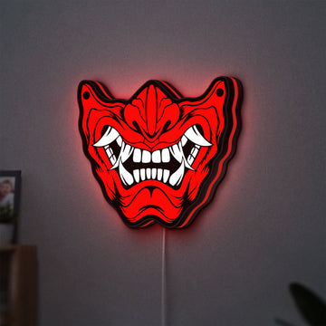 Oni Mas LED lightbox hanging on a wall with red glow