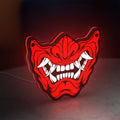 Oni Mas LED lightbox standing on a desk from an angled side view with red glow