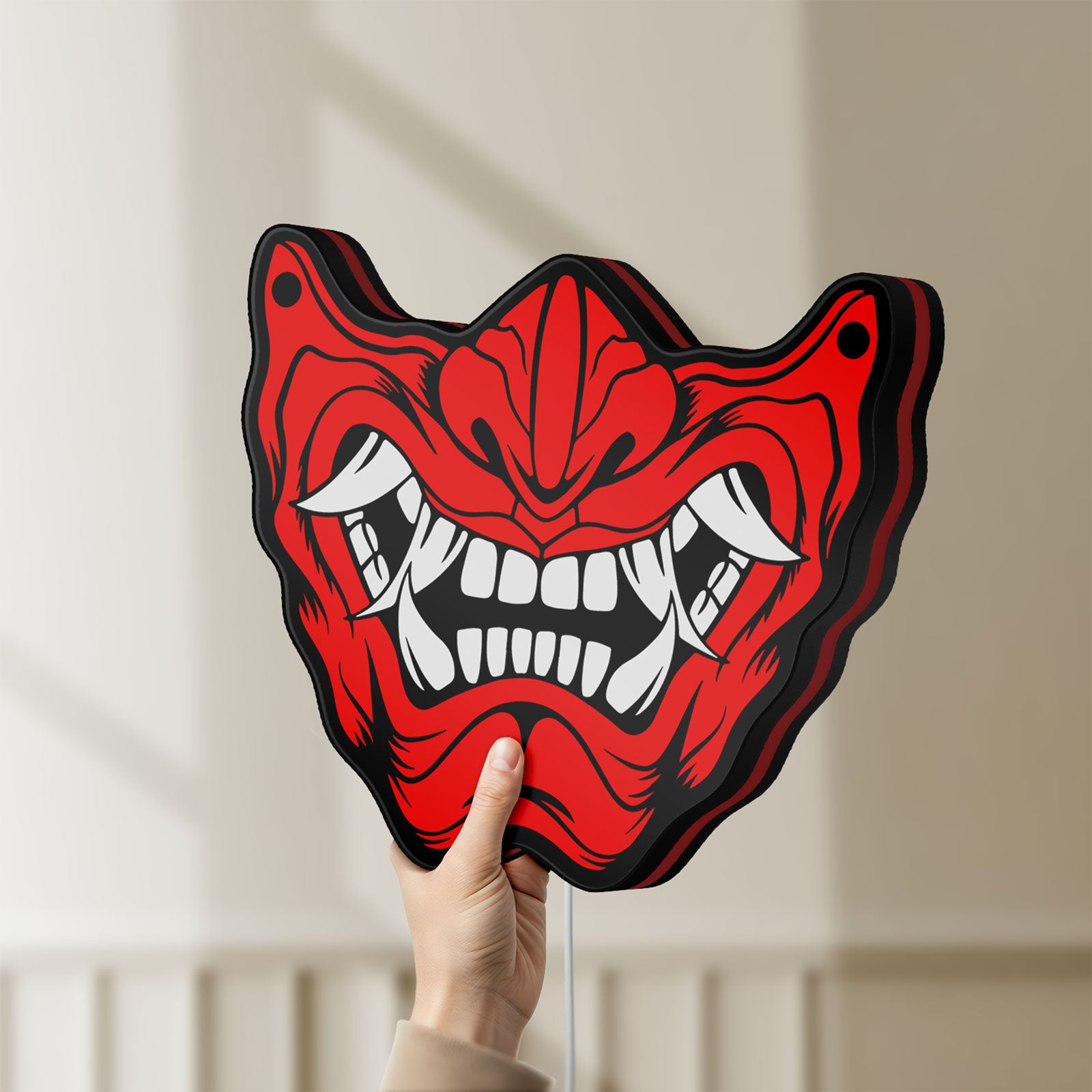 Unlit Oni Mas LED lightbox held by hand to show size and details