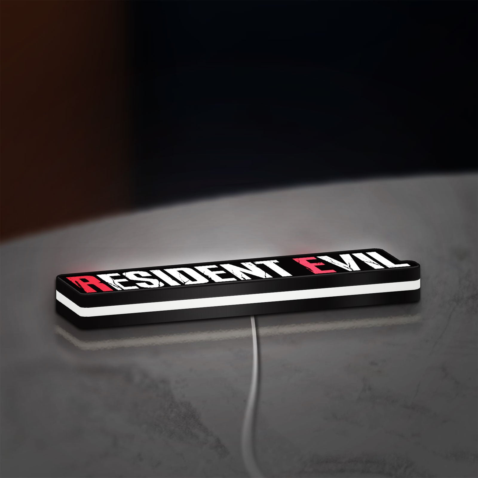 Resident Evil Umbrella Corp Horror LED lightbox lying flat on a desk with white glow