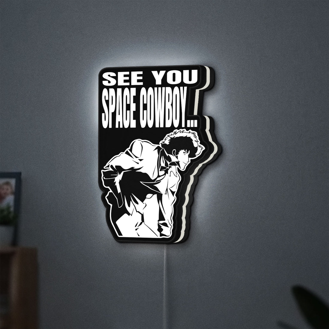 Cowboy Bebop See You Space Cowboy LED lightbox hanging on a wall with white glow