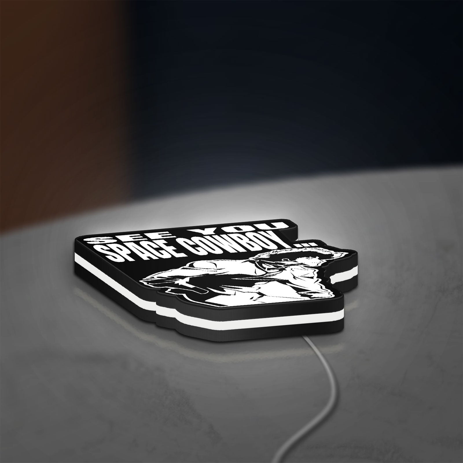 Cowboy Bebop See You Space Cowboy LED lightbox lying flat on a desk with white glow
