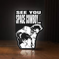 Front view of Cowboy Bebop See You Space Cowboy LED lightbox sign glowing on a wooden desk
