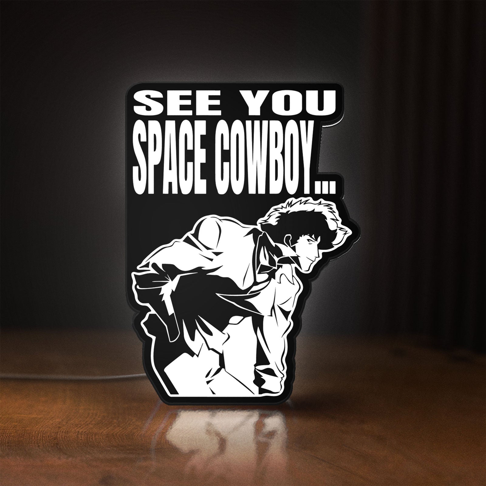 Front view of Cowboy Bebop See You Space Cowboy LED lightbox sign glowing on a wooden desk