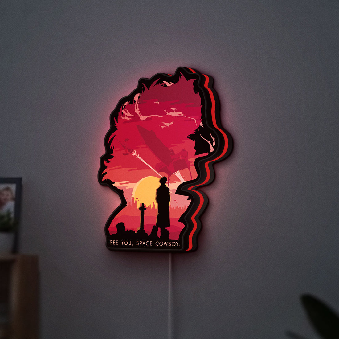 Cowboy Bebop See You Space Cowboy LED lightbox hanging on a wall with red glow