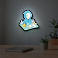 Slay the Spire Roguelike Game LED lightbox hanging on a room wall with soft blue light