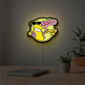 Futurama Slurm Cola Sci-Fi Comedy LED lightbox hanging on a room wall with soft yellow light