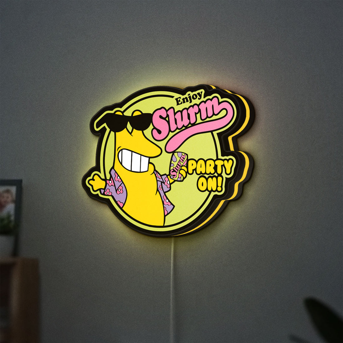 Futurama Slurm Cola Sci-Fi Comedy LED lightbox hanging on a wall with yellow glow