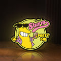 Front view of Futurama Slurm Cola Sci-Fi Comedy LED lightbox sign glowing on a wooden desk