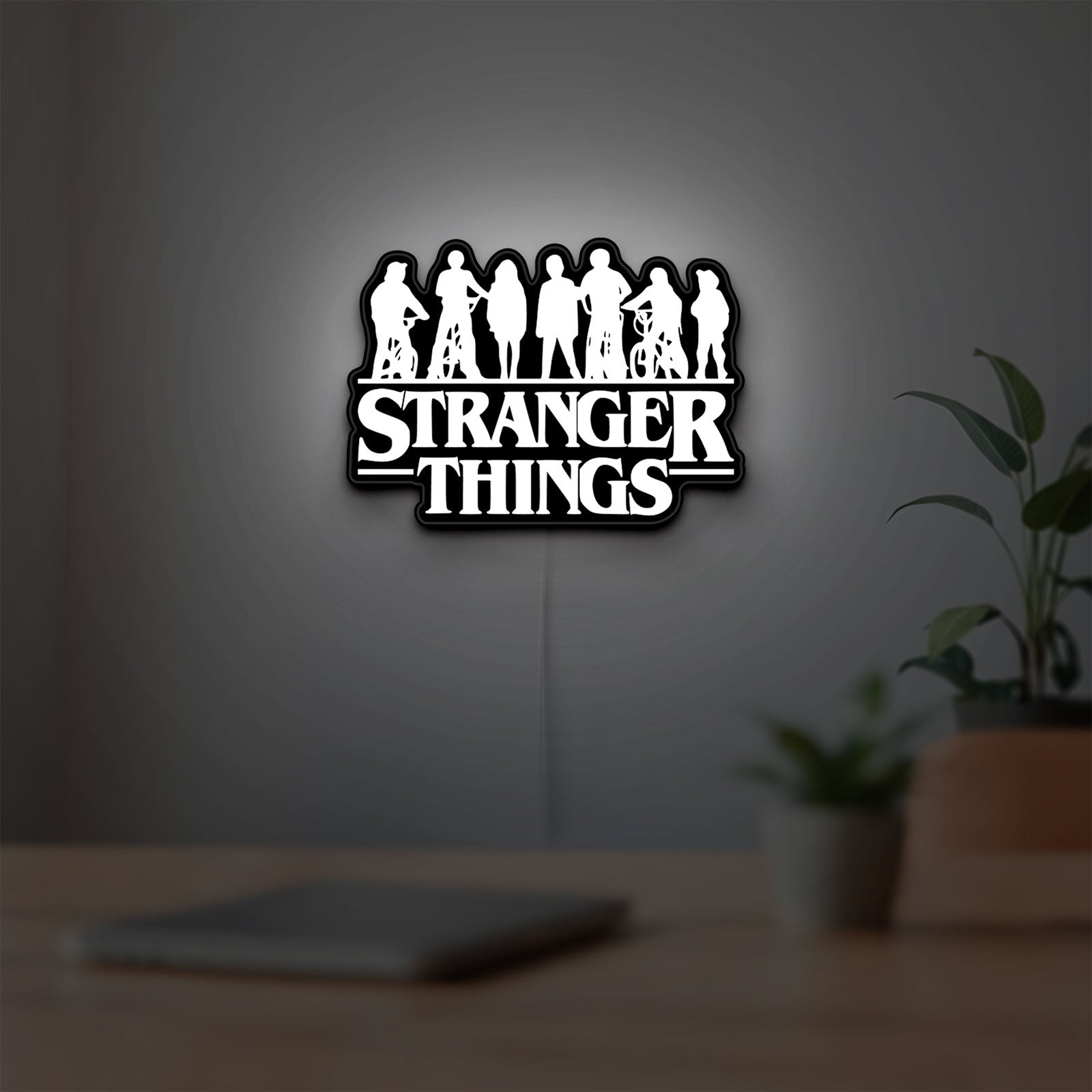 Stranger Things Logo The Upside Down LED lightbox hanging on a room wall with soft white light