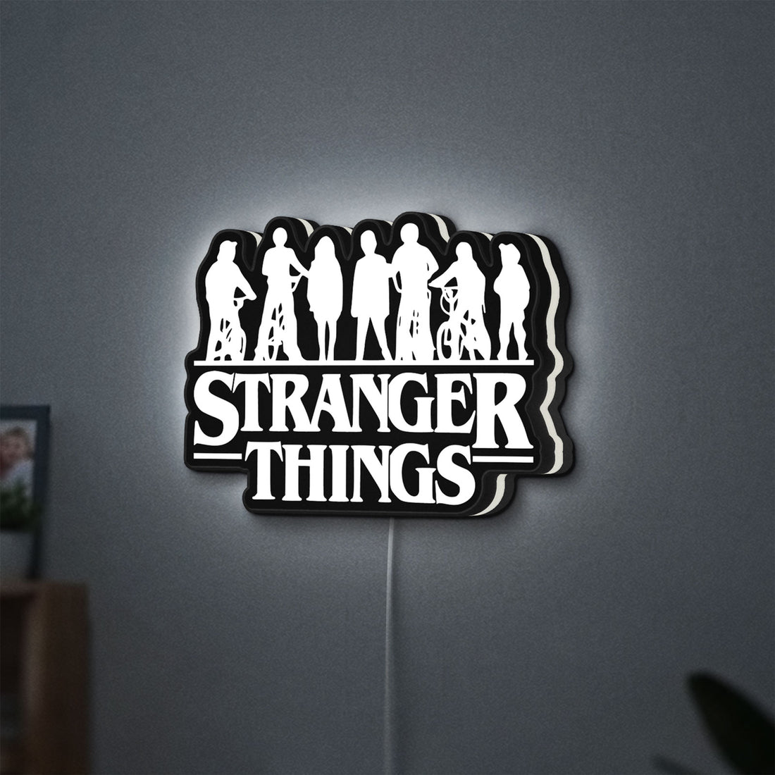 Stranger Things Logo The Upside Down LED lightbox hanging on a wall with white glow