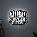 Stranger Things Logo The Upside Down LED lightbox hanging on a wall with white glow