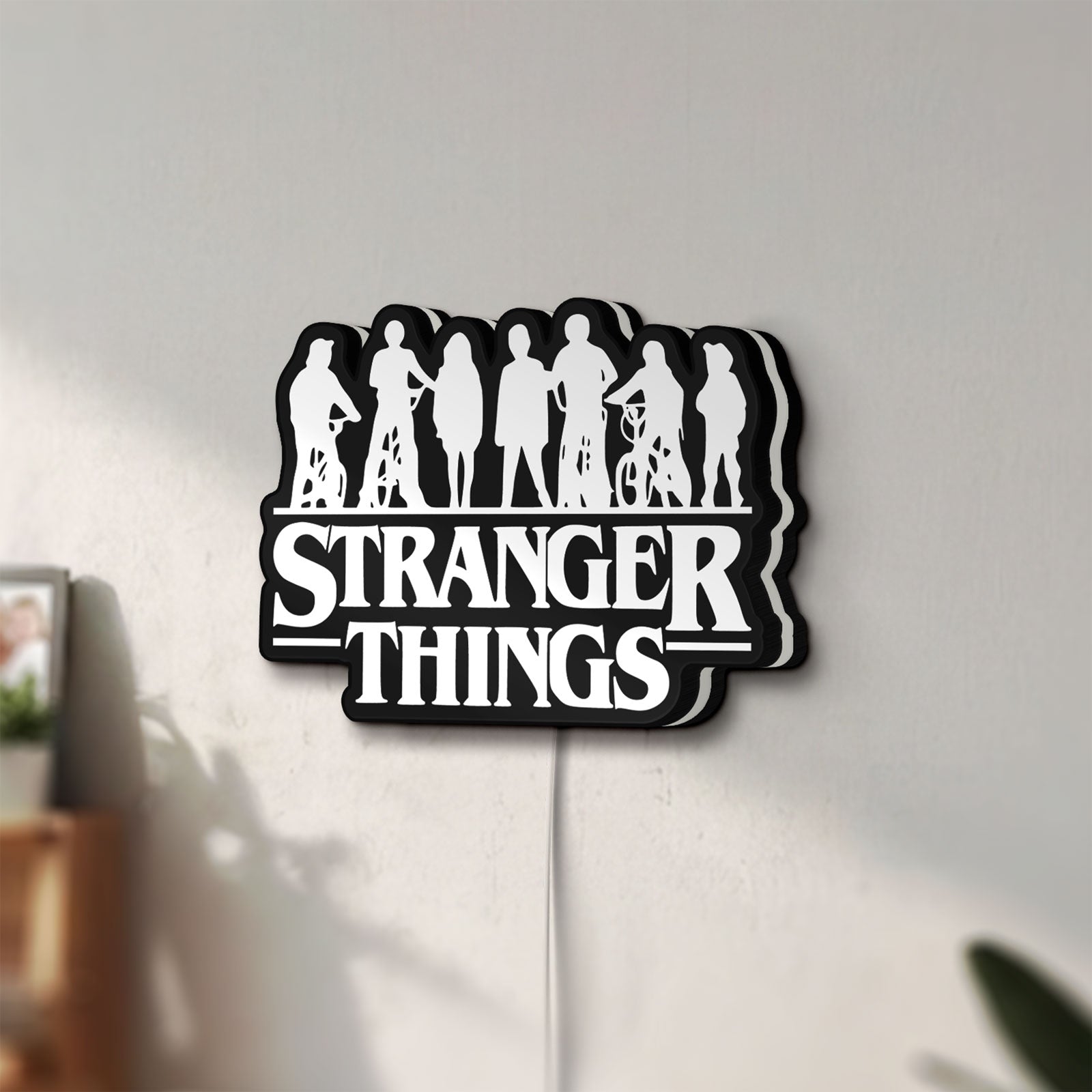 Unlit Stranger Things Logo The Upside Down LED lightbox mounted on a wall in daylight