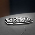 Stranger Things Logo The Upside Down LED lightbox lying flat on a desk with white glow