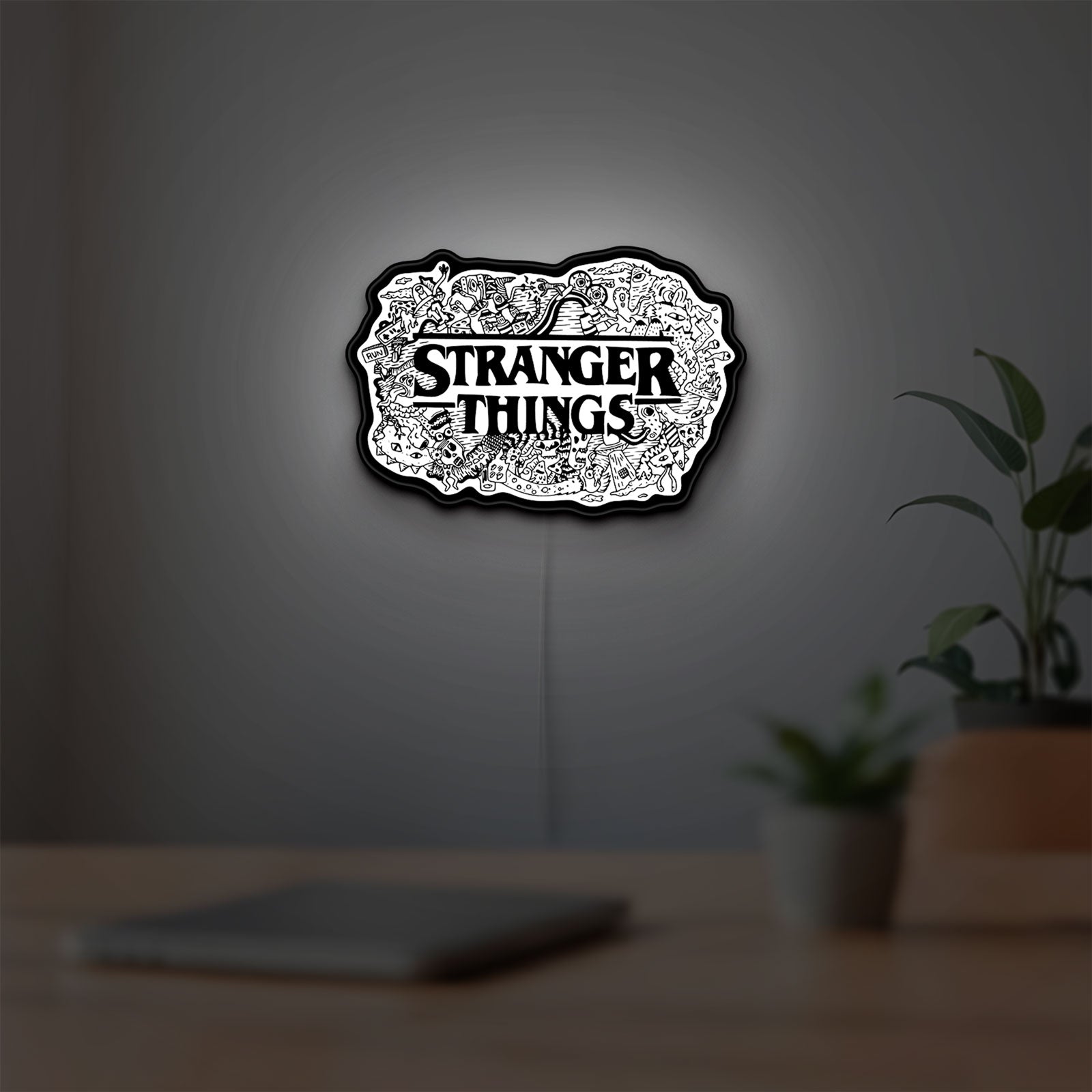 Stranger Things Logo The Upside Down LED lightbox hanging on a room wall with soft white light