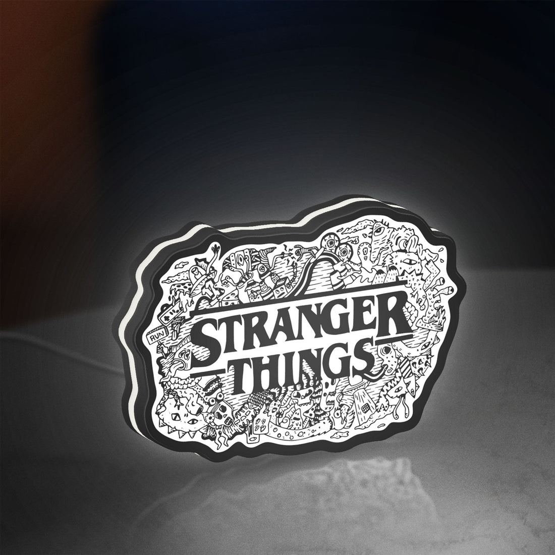 Stranger Things Logo The Upside Down LED lightbox hanging on a wall with white glow