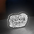 Stranger Things Logo The Upside Down LED lightbox standing on a desk from an angled side view with white glow