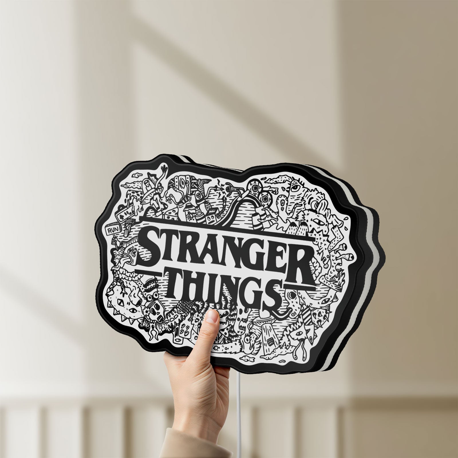 Unlit Stranger Things Logo The Upside Down LED lightbox held by hand to show size and details
