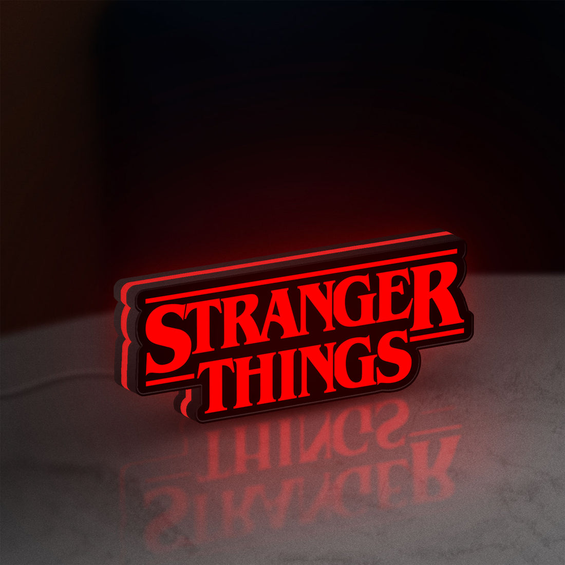 Stranger Things Logo The Upside Down LED lightbox hanging on a wall with red glow