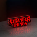 Stranger Things Logo The Upside Down LED lightbox standing on a desk from an angled side view with red glow