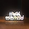 Front view of Stray Kids SKZOO K-Pop Mascot LED lightbox sign glowing on a wooden desk