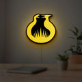 Hunger Games Sunrise on the Reaping LED lightbox hanging on a room wall with soft yellow light