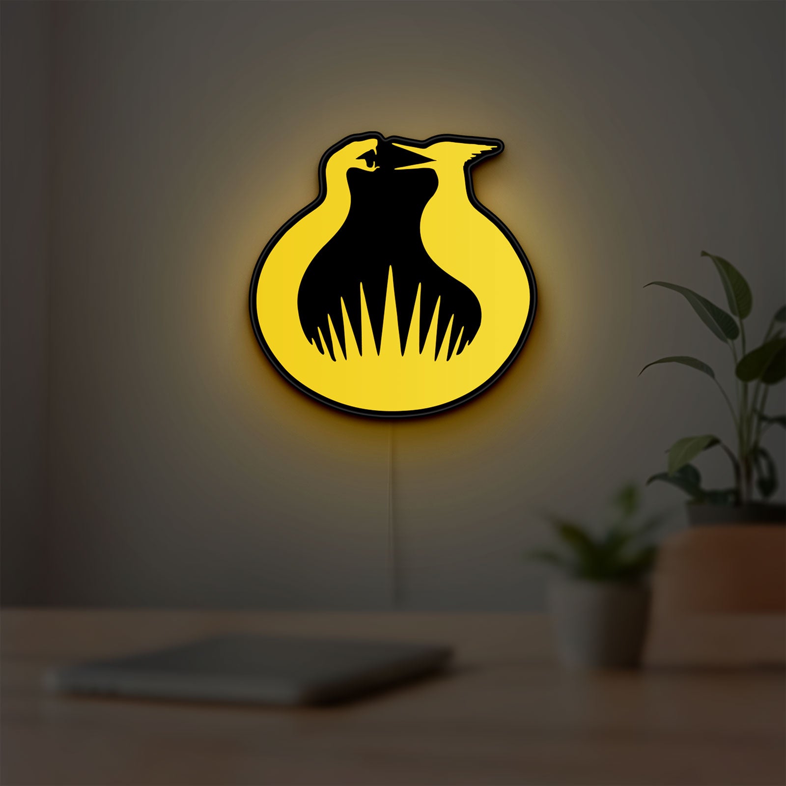 Hunger Games Sunrise on the Reaping LED lightbox hanging on a room wall with soft yellow light