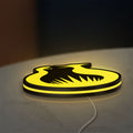 Hunger Games Sunrise on the Reaping LED lightbox lying flat on a desk with yellow glow