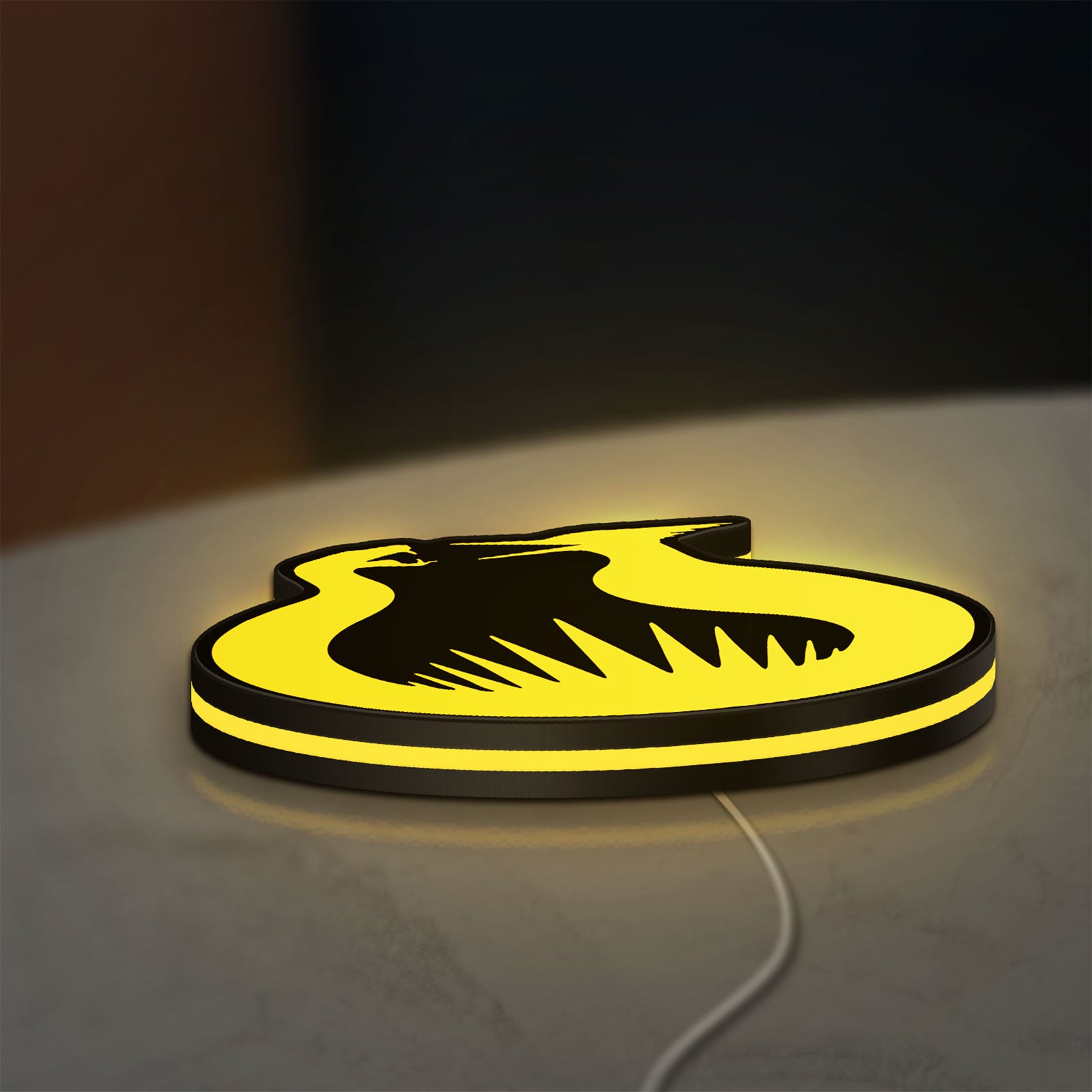 Hunger Games Sunrise on the Reaping LED lightbox lying flat on a desk with yellow glow