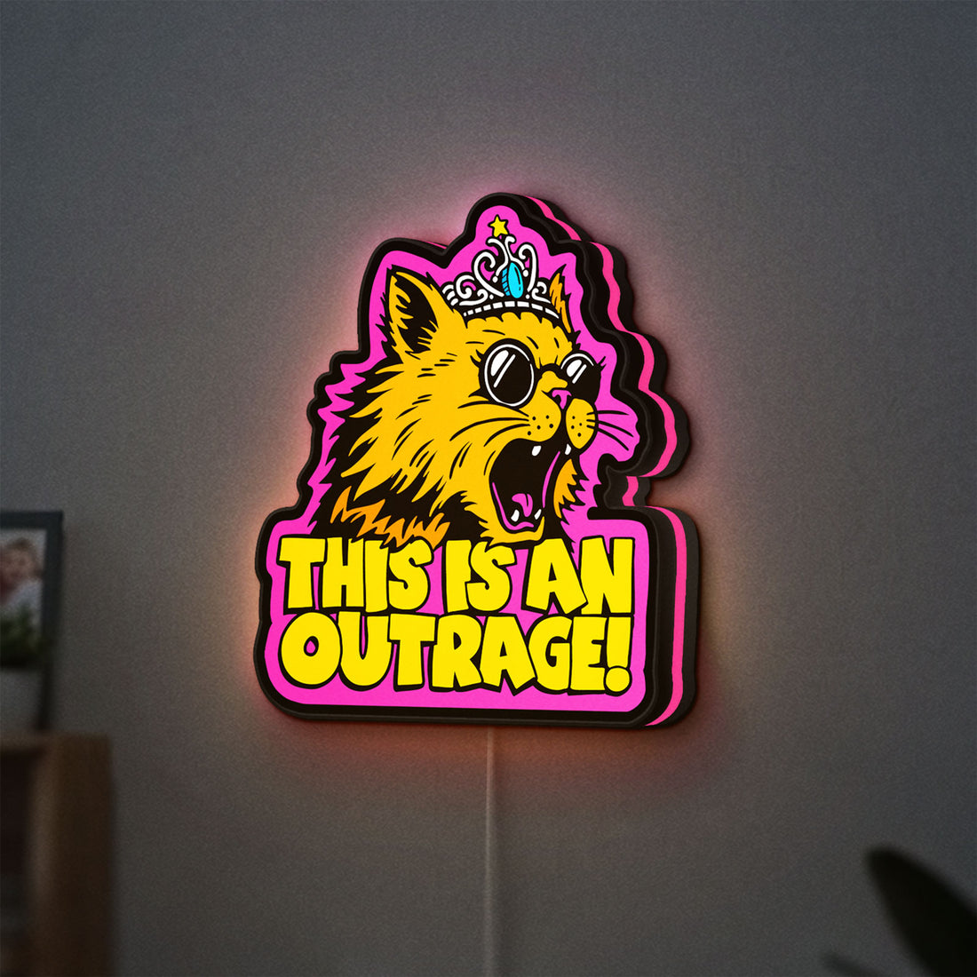 This is an Outrage Meme Funny Quote LED lightbox hanging on a wall with pink glow