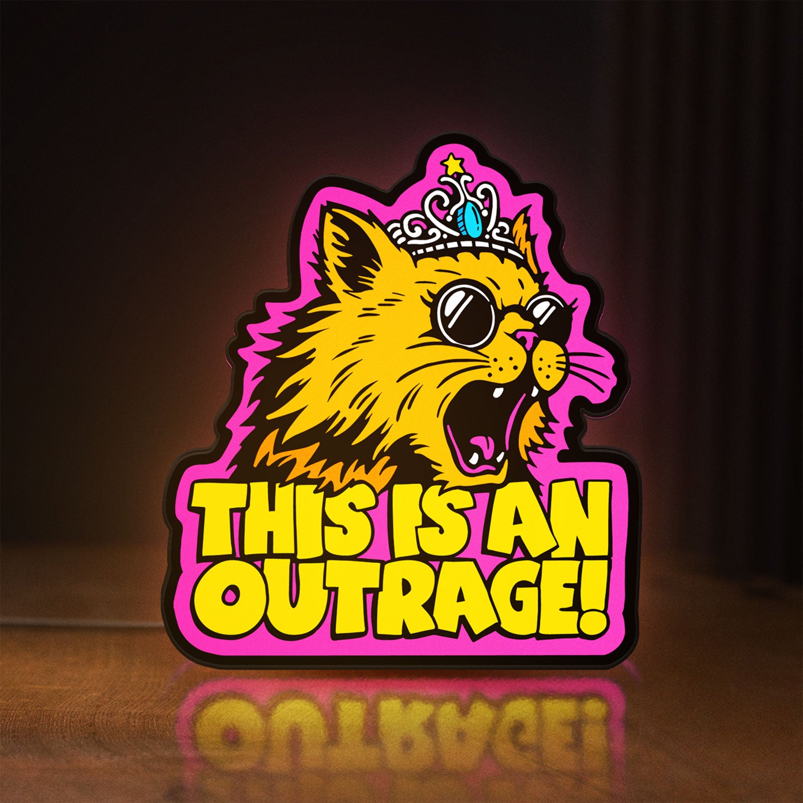 Front view of This is an Outrage Meme Funny Quote LED lightbox sign glowing on a wooden desk