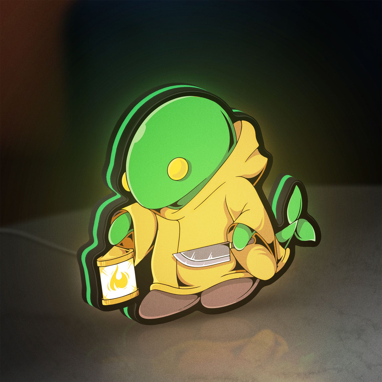 Final Fantasy Tonberry RPG Monster LED lightbox standing on a desk from an angled side view with green glow