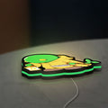 Final Fantasy Tonberry RPG Monster LED lightbox lying flat on a desk with green glow