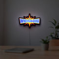 WWE WrestleMania Pro Wrestling LED lightbox hanging on a room wall with soft yellow light