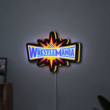 WWE WrestleMania Pro Wrestling LED lightbox hanging on a wall with yellow glow