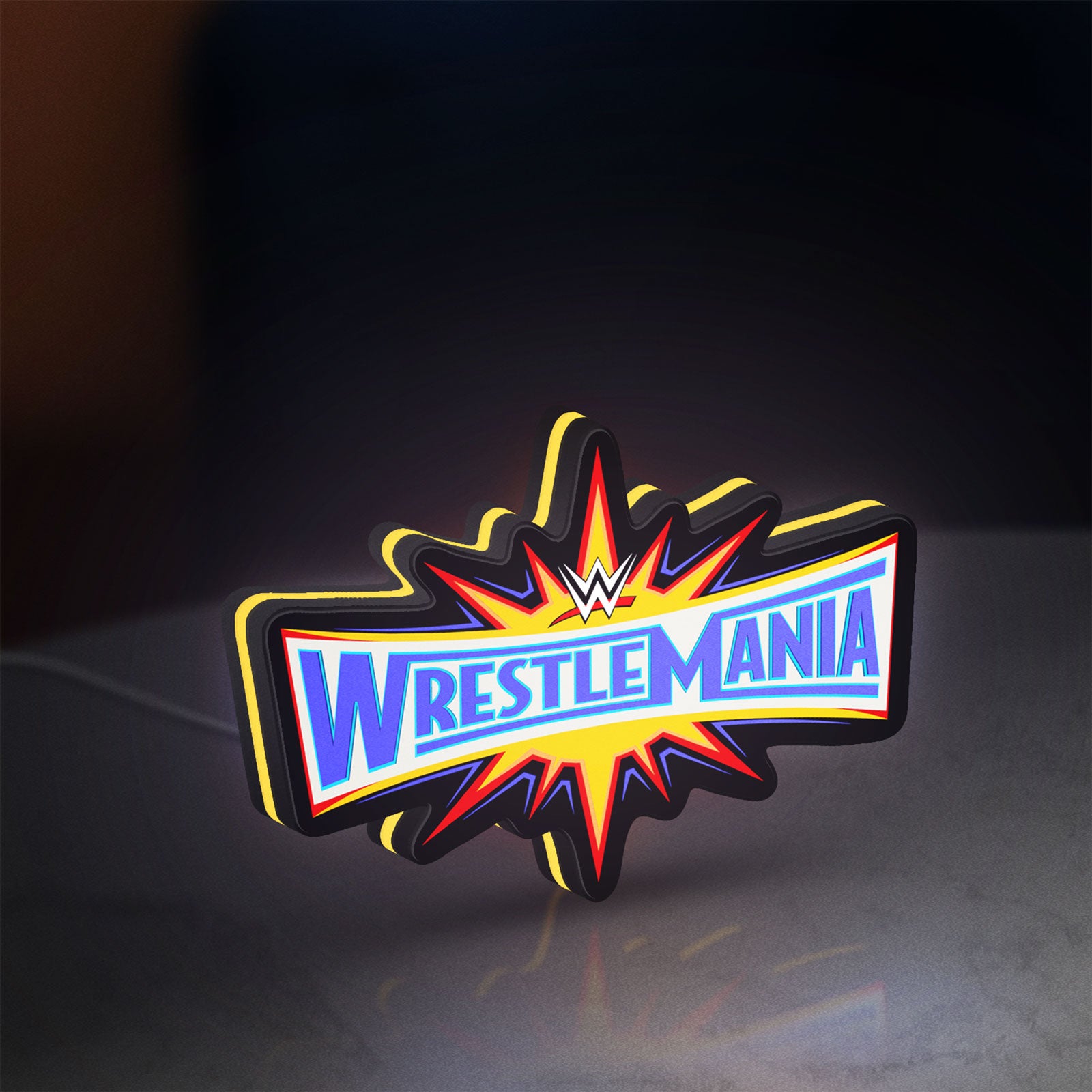 WWE WrestleMania Pro Wrestling LED lightbox standing on a desk from an angled side view with yellow glow