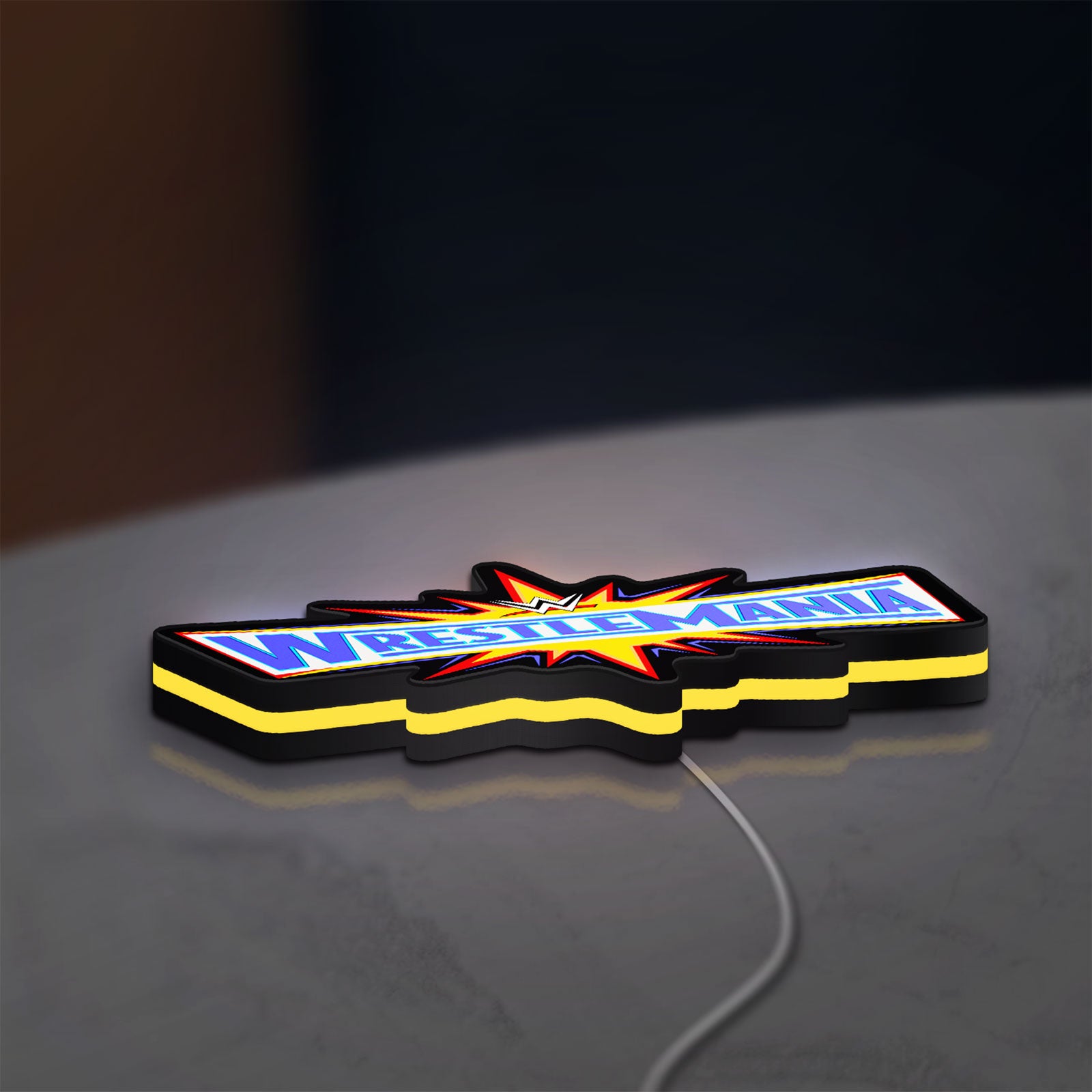 WWE WrestleMania Pro Wrestling LED lightbox lying flat on a desk with yellow glow