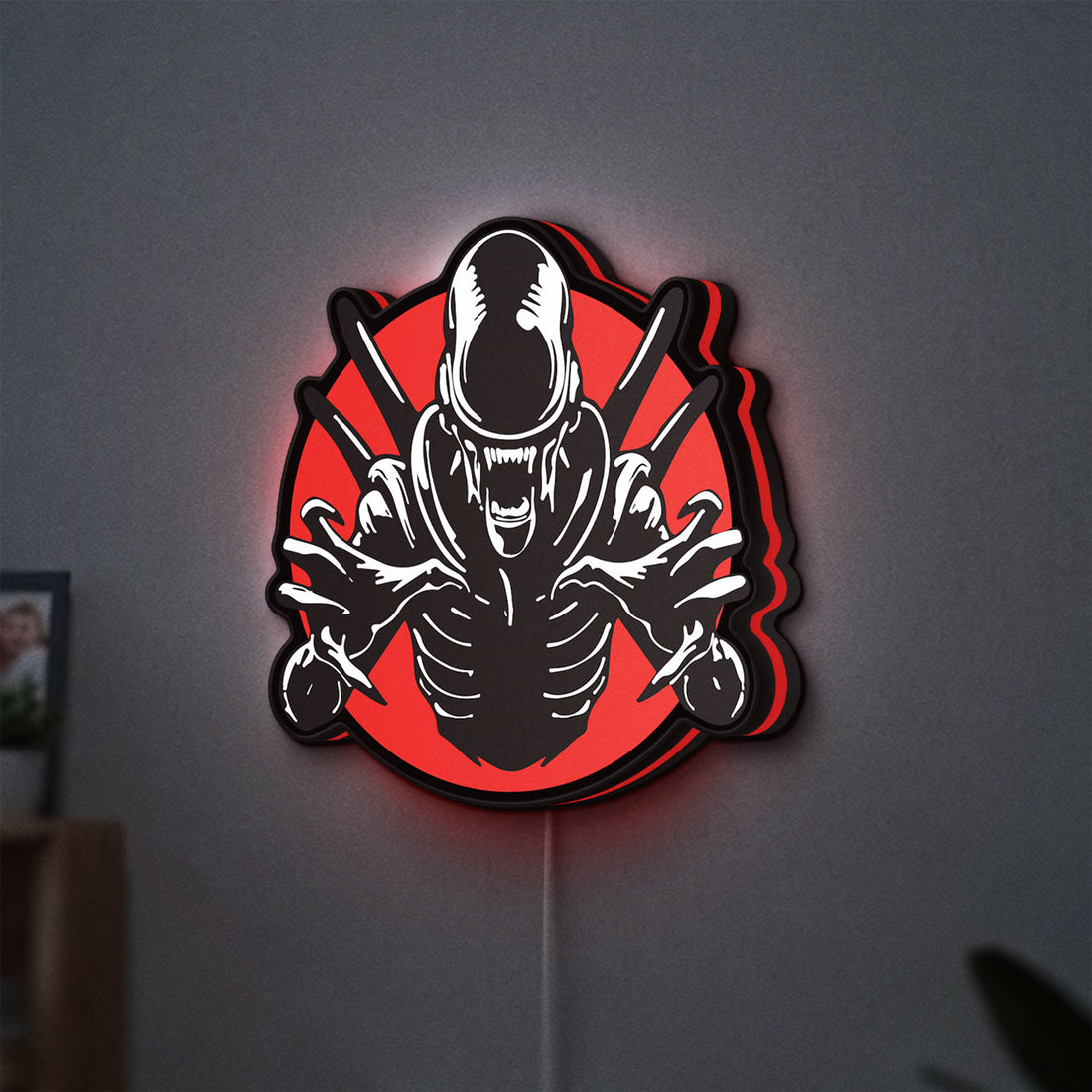 Alien Xenomorph Sci-Fi Horror Movie LED lightbox hanging on a wall with red glow