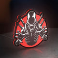 Alien Xenomorph Sci-Fi Horror Movie LED lightbox standing on a desk from an angled side view with red glow