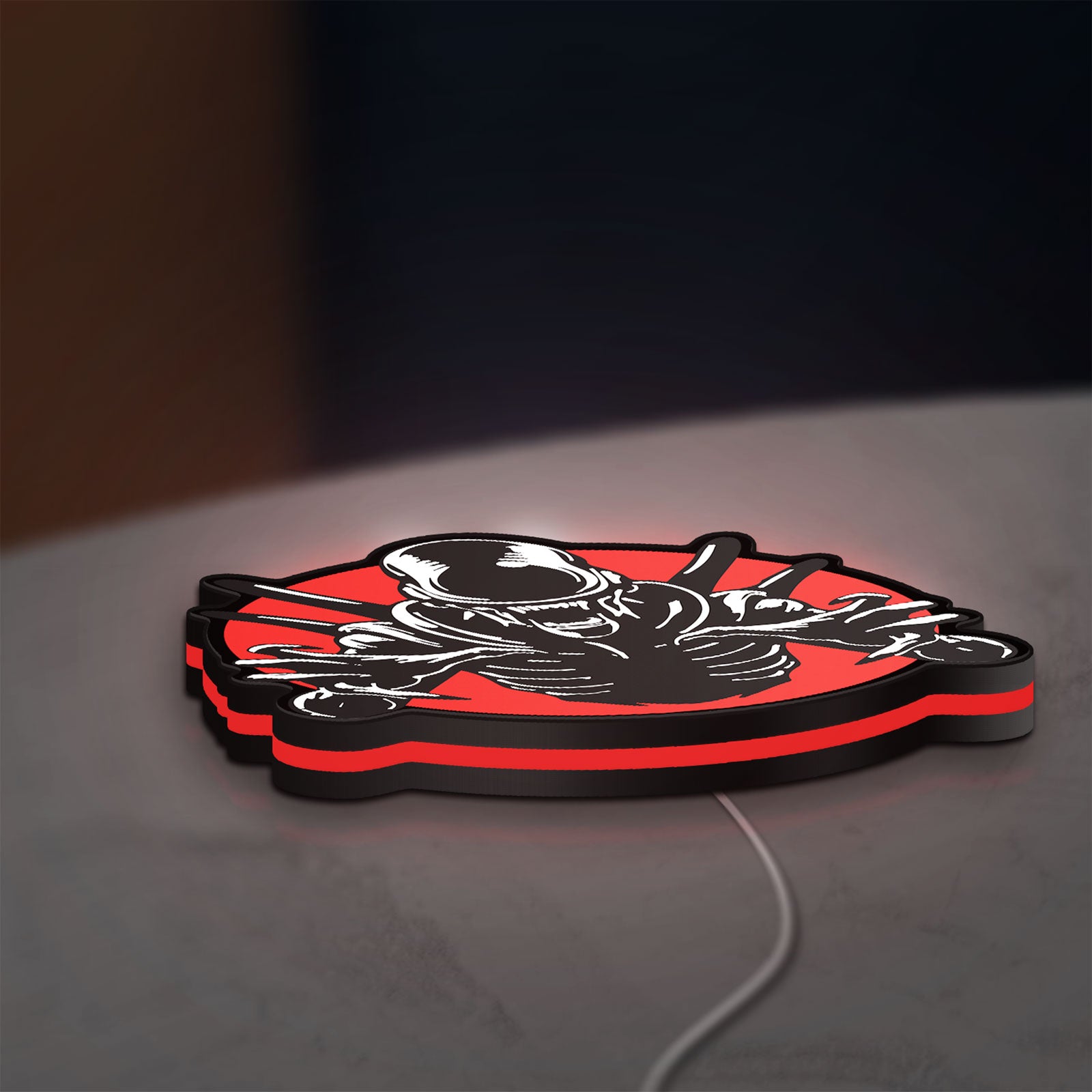 Alien Xenomorph Sci-Fi Horror Movie LED lightbox lying flat on a desk with red glow