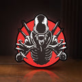 Front view of Alien Xenomorph Sci-Fi Horror Movie LED lightbox sign glowing on a wooden desk